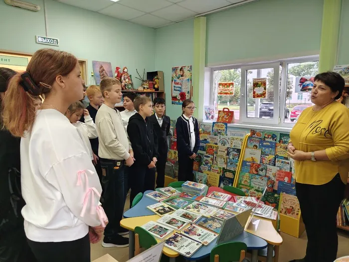 Библиотекарь проводит обзор книжной выставки Караван книг для учащихся