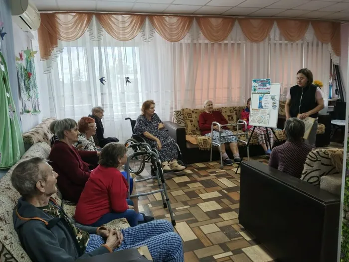 Библиотекарь и участники часа здоровья выполняют интерактивное задание на знание видов спорта